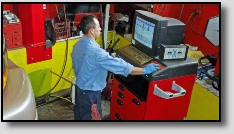 Mechanic Using Computer Diagnostics at Precise Auto Service